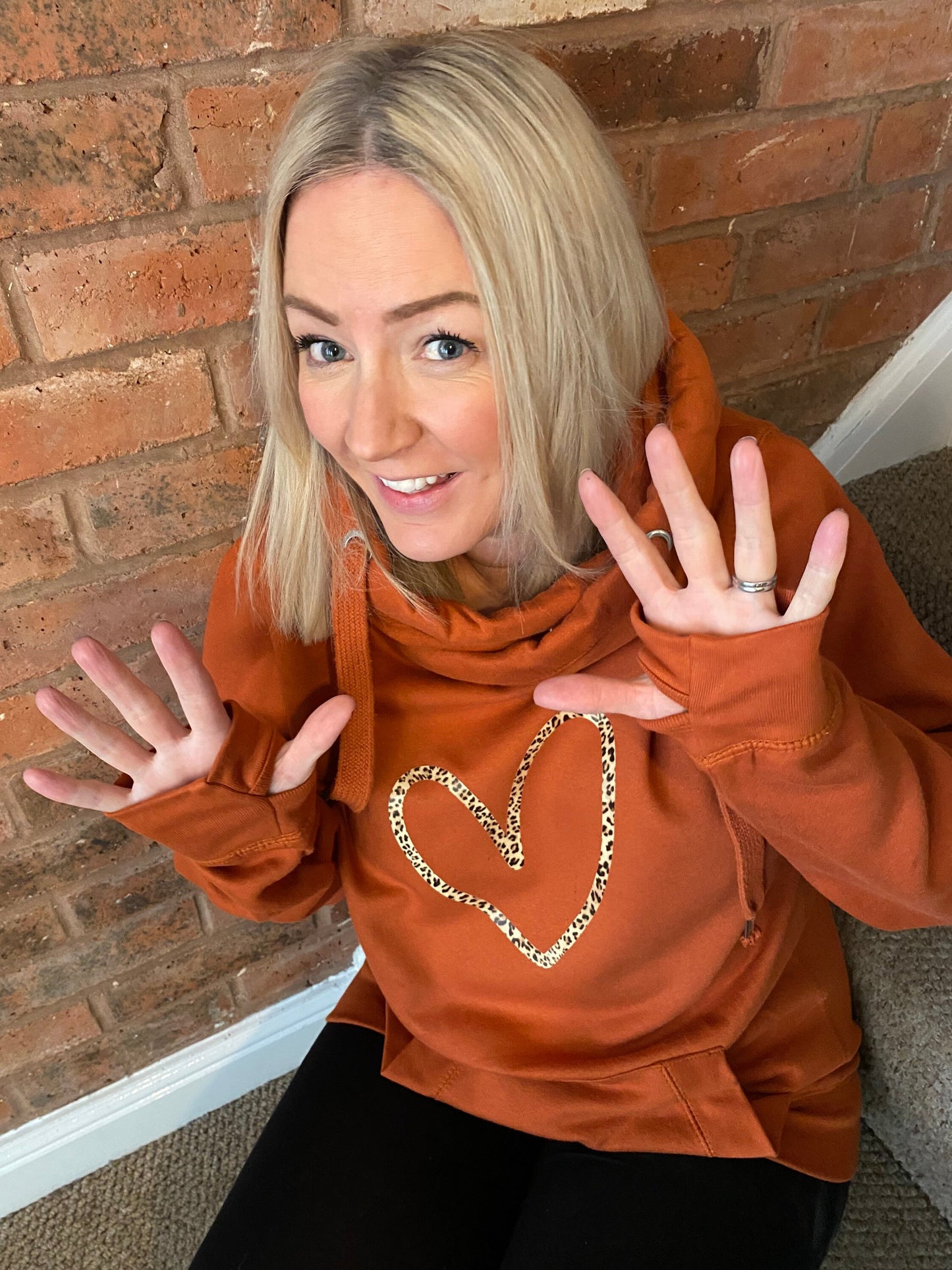 Cowl neck hoodie in orange with leopard heart print