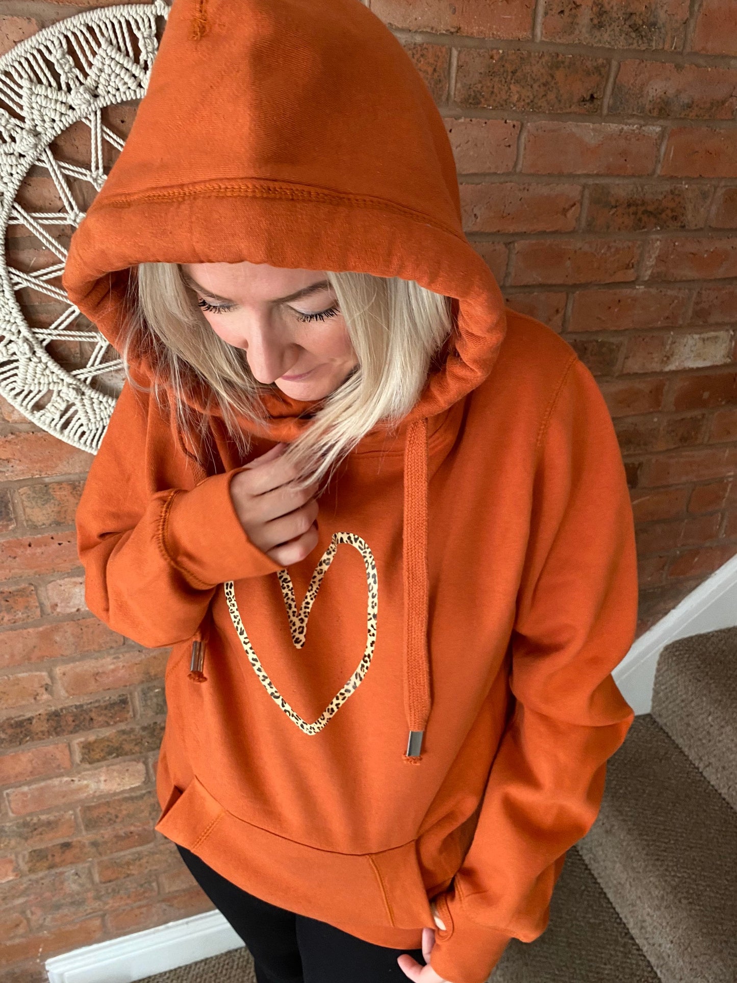 Cowl neck hoodie in orange with leopard heart print