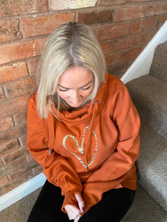 Cowl neck hoodie in orange with leopard heart print